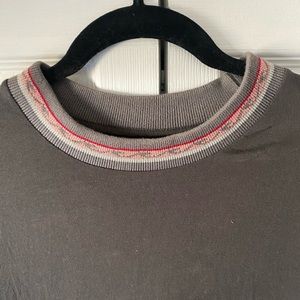 A grey long sleeve t-shirt with wave design detail